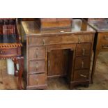 19th Century walnut kneehole desk having long drawer above central shallow drawer with inset