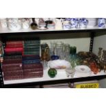 Shelf assortment of books, glass, ceramics and metalwares.