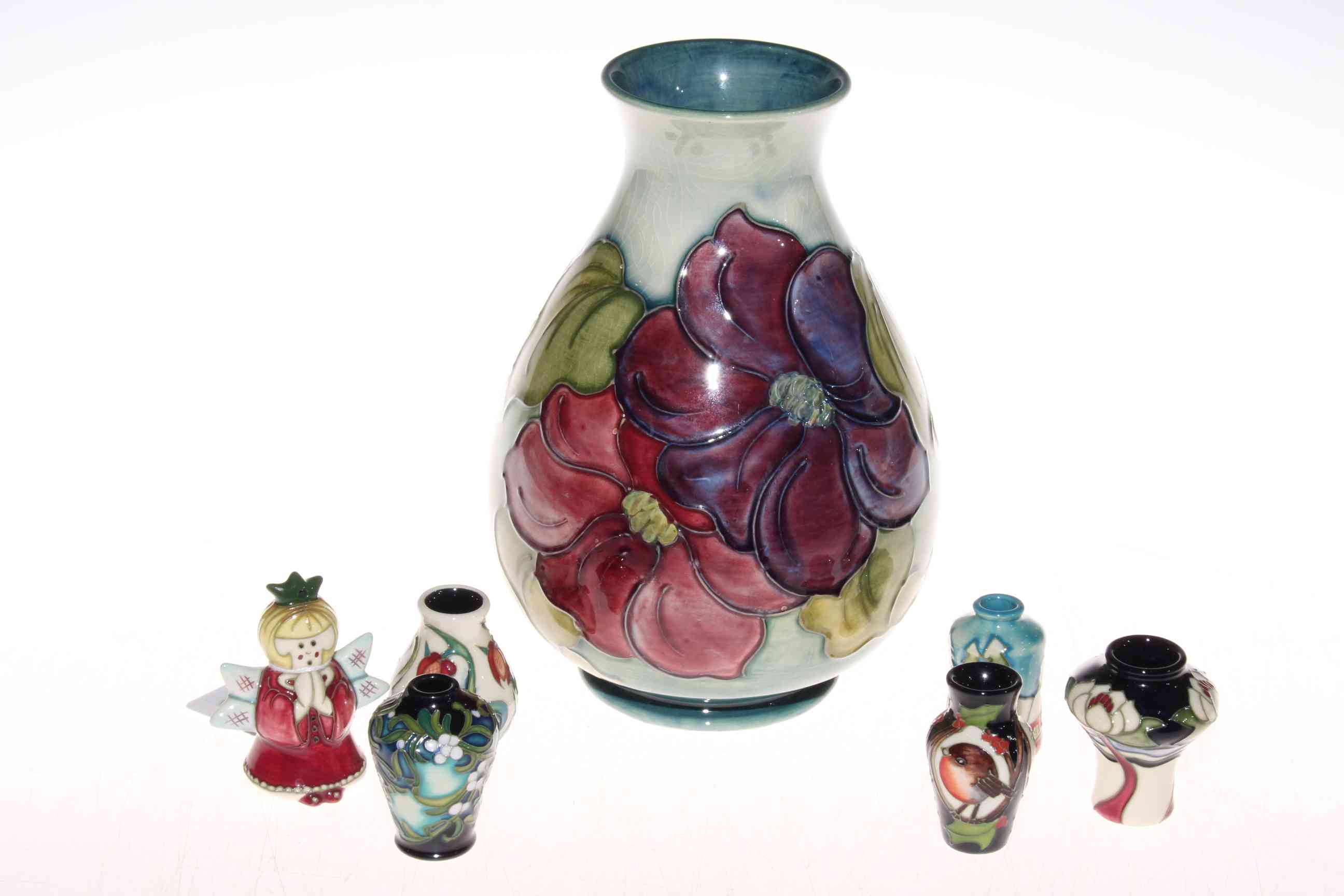 Moorcroft Clematis vase and five small Moorcroft vases and an angel figurine (7).
