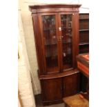 Strongbow mahogany four door shaped front mahogany illuminated display cabinet.