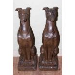 Pair of composite seated greyhounds, 79cm tall.