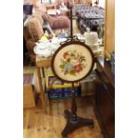 Victorian rosewood triform polescreen with circular floral needlework panel.