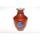 Chinese vase with blue and white panels and bats on red ground, blue mark to base, 22.5cm.