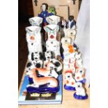 Collection of Staffordshire dogs, flat backs and spill vases.