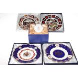 Four Royal Crown Derby plates including two Christmas plates and commemorative mug.