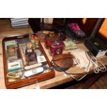 Collection of tins, vintage telephones, binoculars, musical photograph album, cased napkin rings,