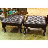 Two deep buttoned red leather footstools on cabriole legs.