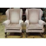 Pair wing fireside armchairs on carved and ball and claw feet.
