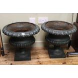 Pair of cast pedestal garden urns, 44cm high.