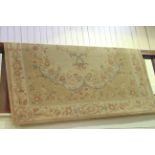 Fawn ground floral design wood rug, 240cm by 170cm.