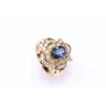 Impressive cushion sapphire and diamond ring set in 18 carat yellow gold,