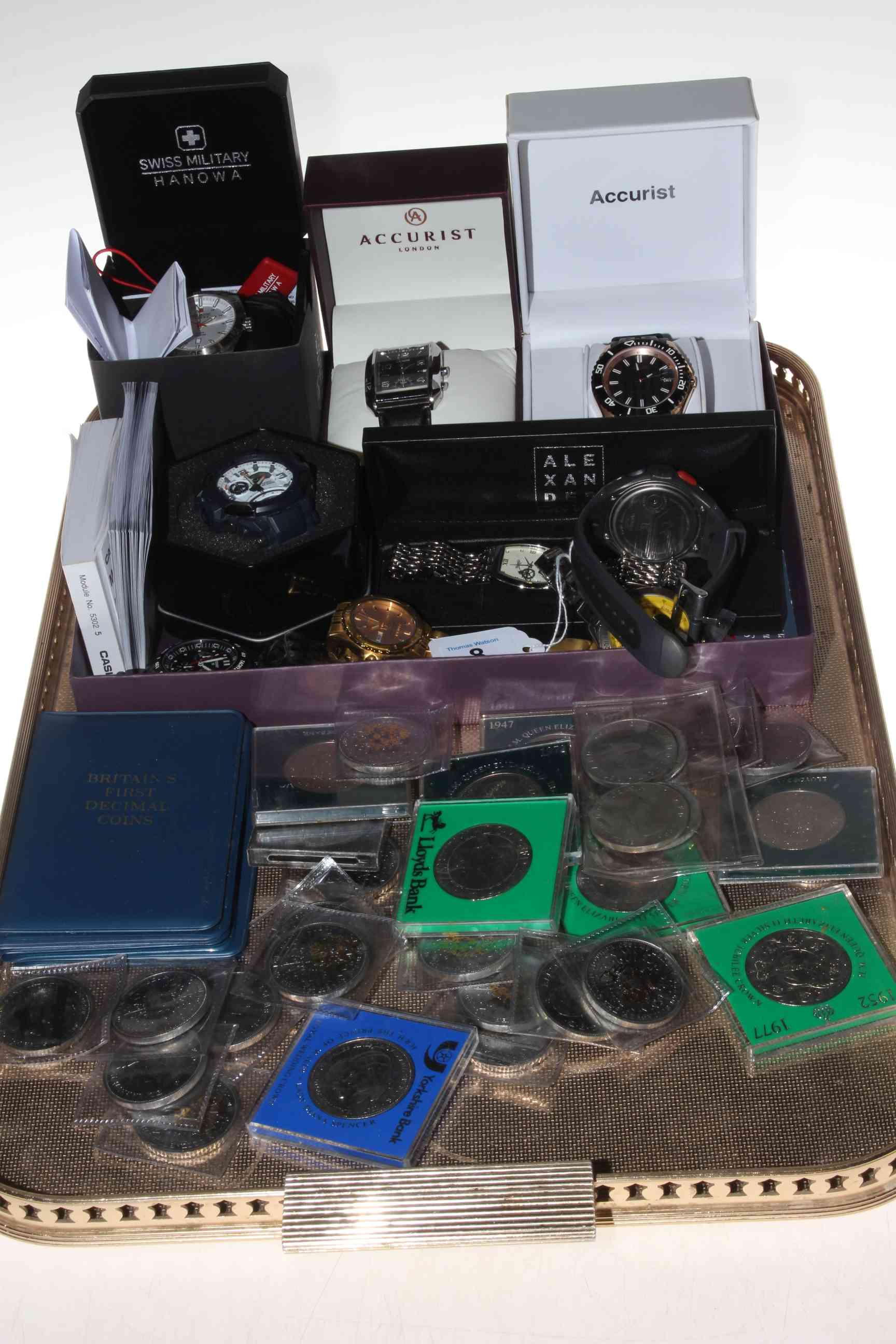 Collection of wristwatches and coins.