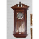 Oak cased wall clock with silvered dial.