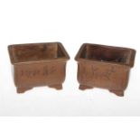 Pair Chinese Zisha Yixing planters having incised decoration, 11cm across.