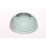 Chinese green celadon brush washer with sea scroll decoration, impressed mark, 11cm diameter.