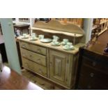 Stripped pine chiffonier having three drawers and cupboard with glass handles, 133cm wide.