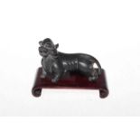 Chinese bronze tiger on wood stand, 10cm length.