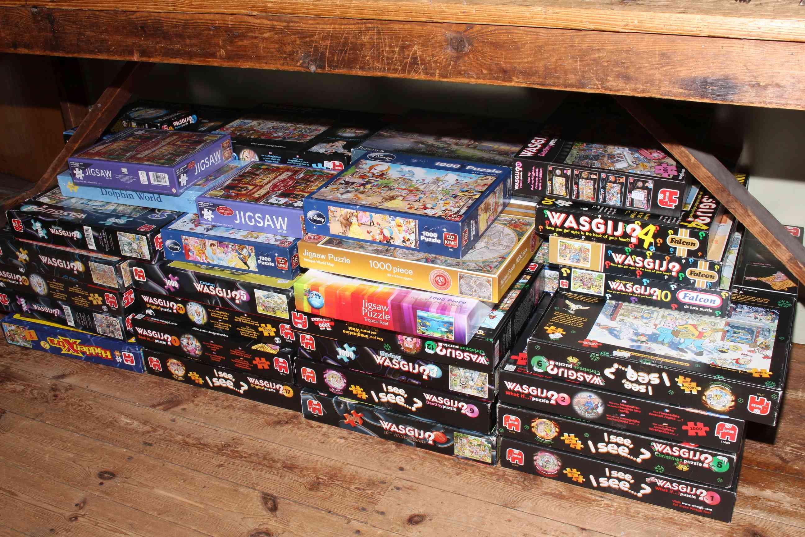 Large assortment of jigsaw puzzles.