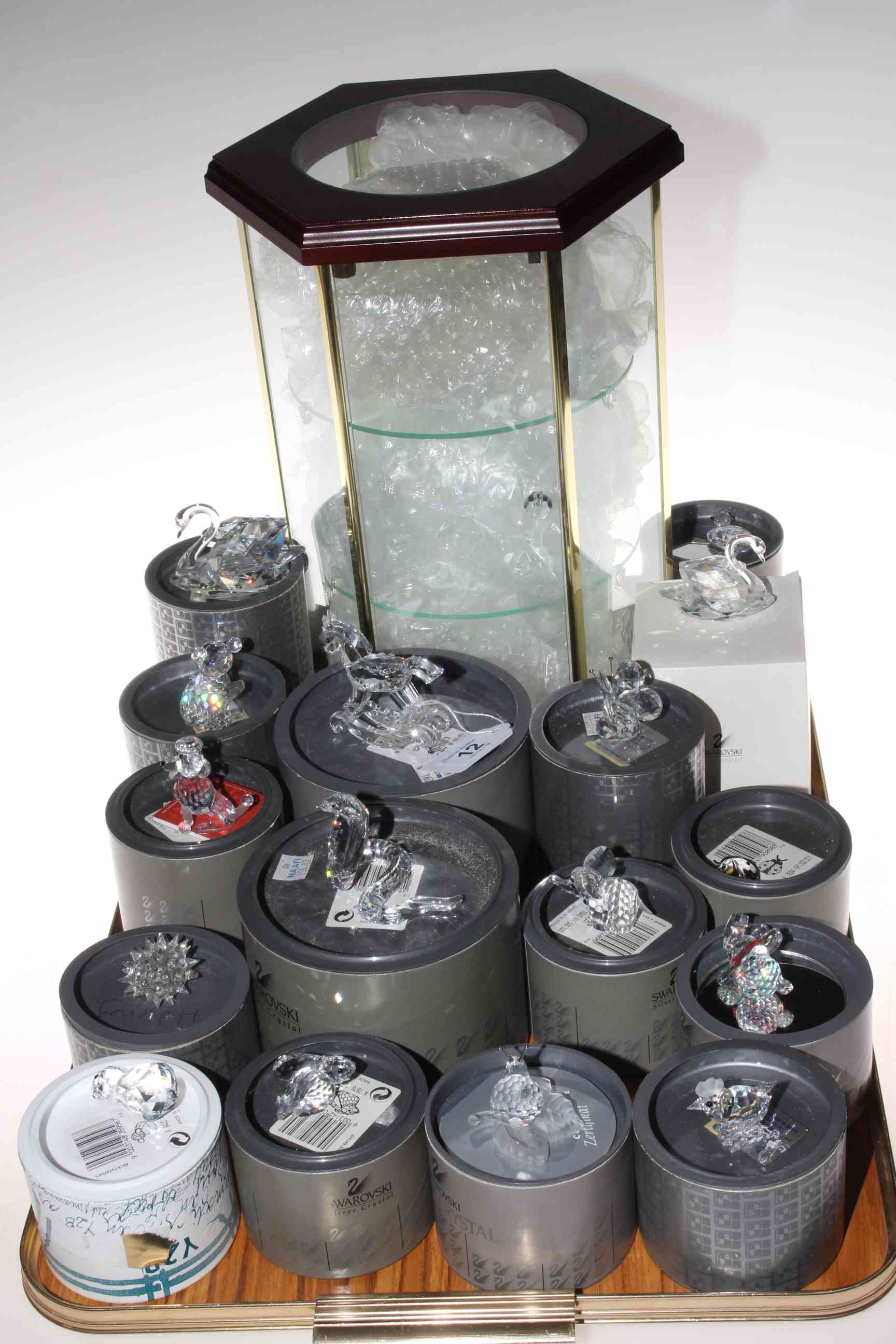 Collection of Swarovski glass ornaments and small octagonal display case.