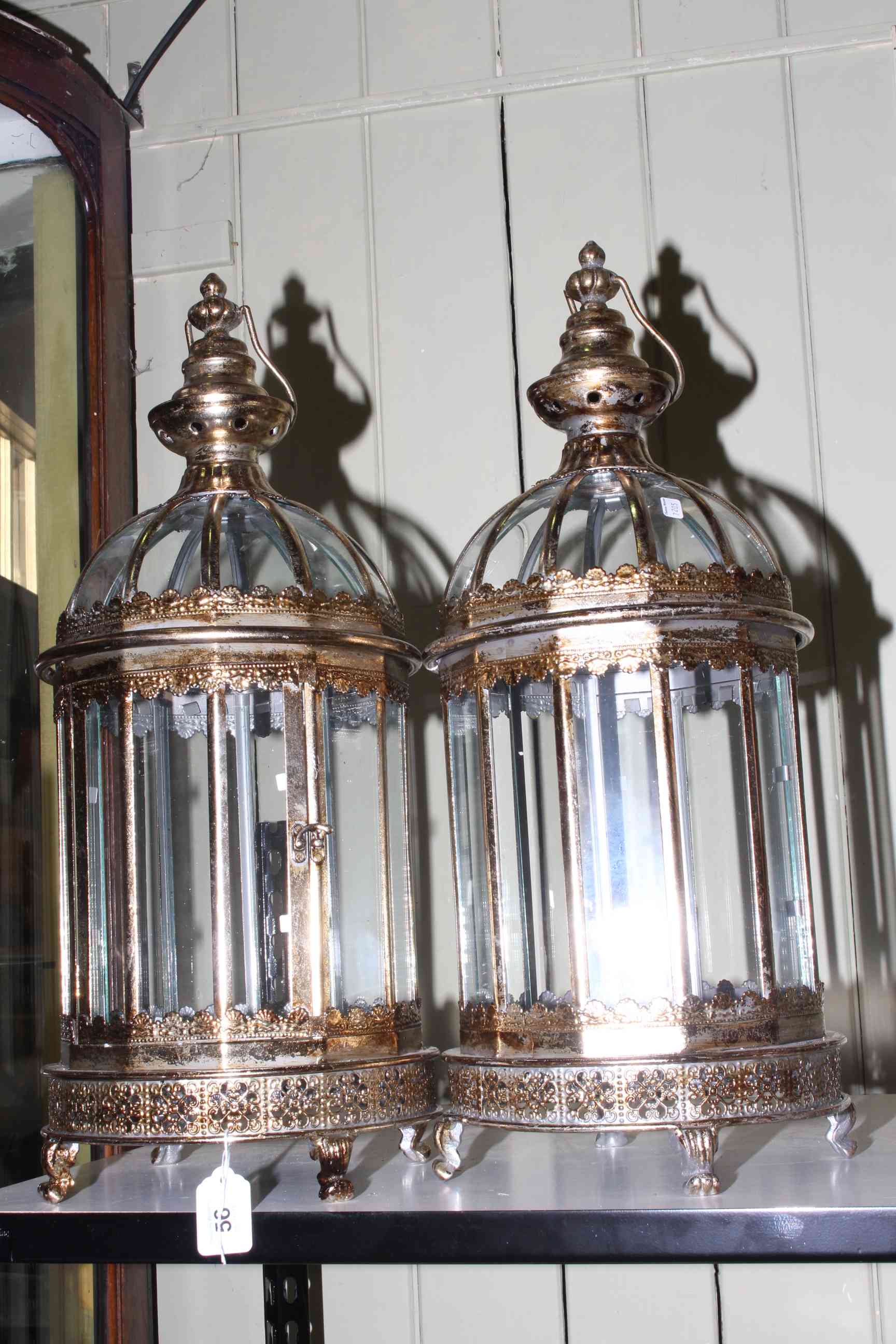 Pair of hanging glass and gilt metal hall lanterns with feet, 62cm.