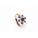 18 carat yellow gold sapphire and diamond cluster ring, having seven sapphires and six diamonds,