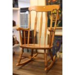 Light wood finish rail back rocking chair.