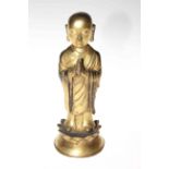 Gilt standing Buddha figure, 23.5cm.