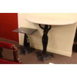 Two cast metal figure based marble top side tables.