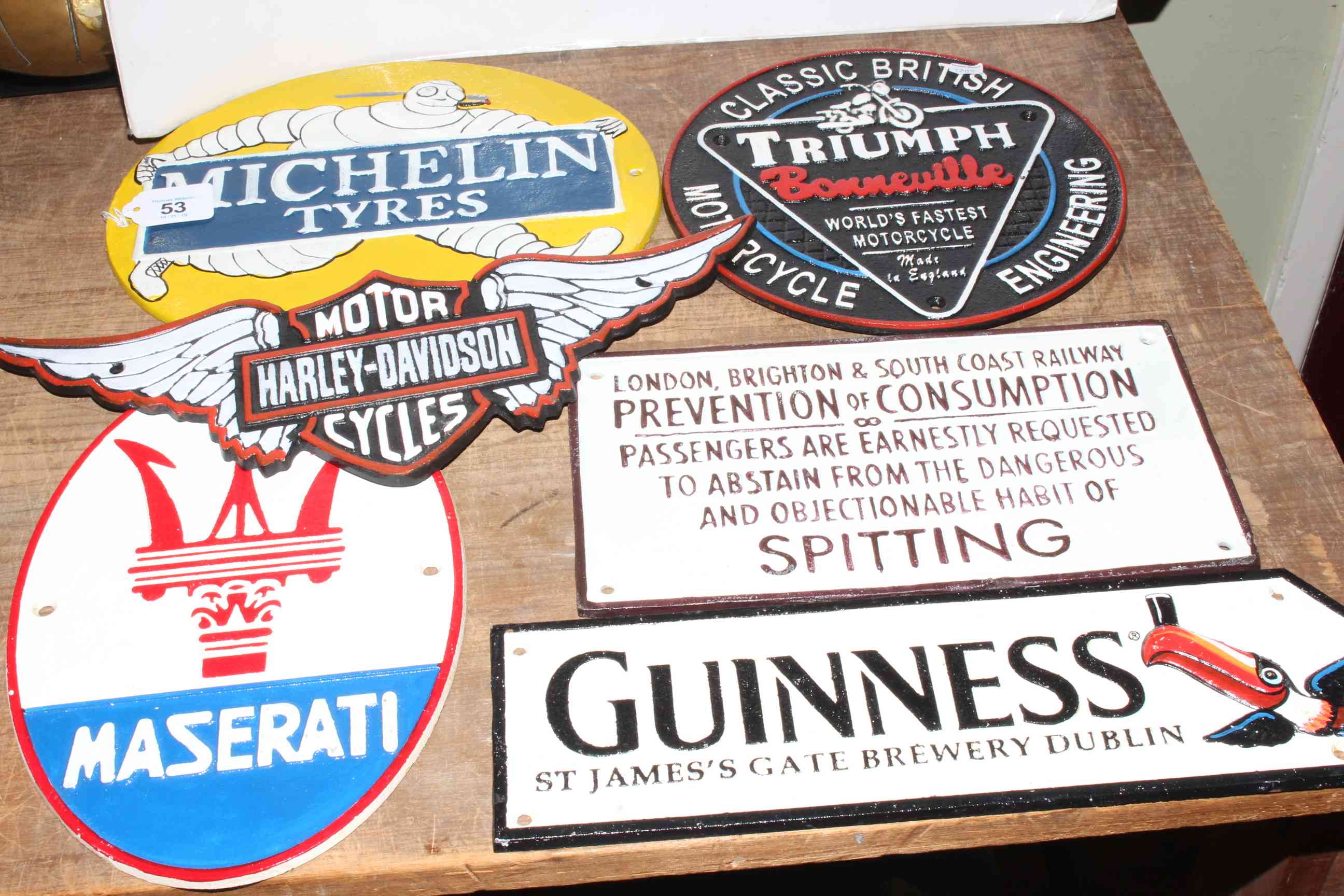 Six cast iron signs including motoring, breweriana and railway interest.