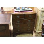 Small inlaid mahogany four height chest on splayed legs.