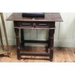 Antique oak side table, the overhang top above frieze drawer and on turned legs, 84cm wide.