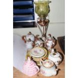 Oil lamp with glass shade, graduated serpent teapots, four decorative teapots and plaques.