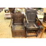 Two antique carved oak panel back armchairs.