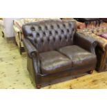 Thomas Lloyd brown leather buttoned back two seater settee.