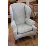 Wing back armchair on cabriole legs.