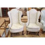 Pair arched wing back armchairs on ball and claw legs.