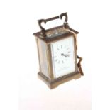Gilt brass 'The Chester Carriage Clock Company' clock with bevelled glass panels.