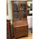 Early 20th Century oak bureau bookcase having two leaded glass doors above a fall front with three