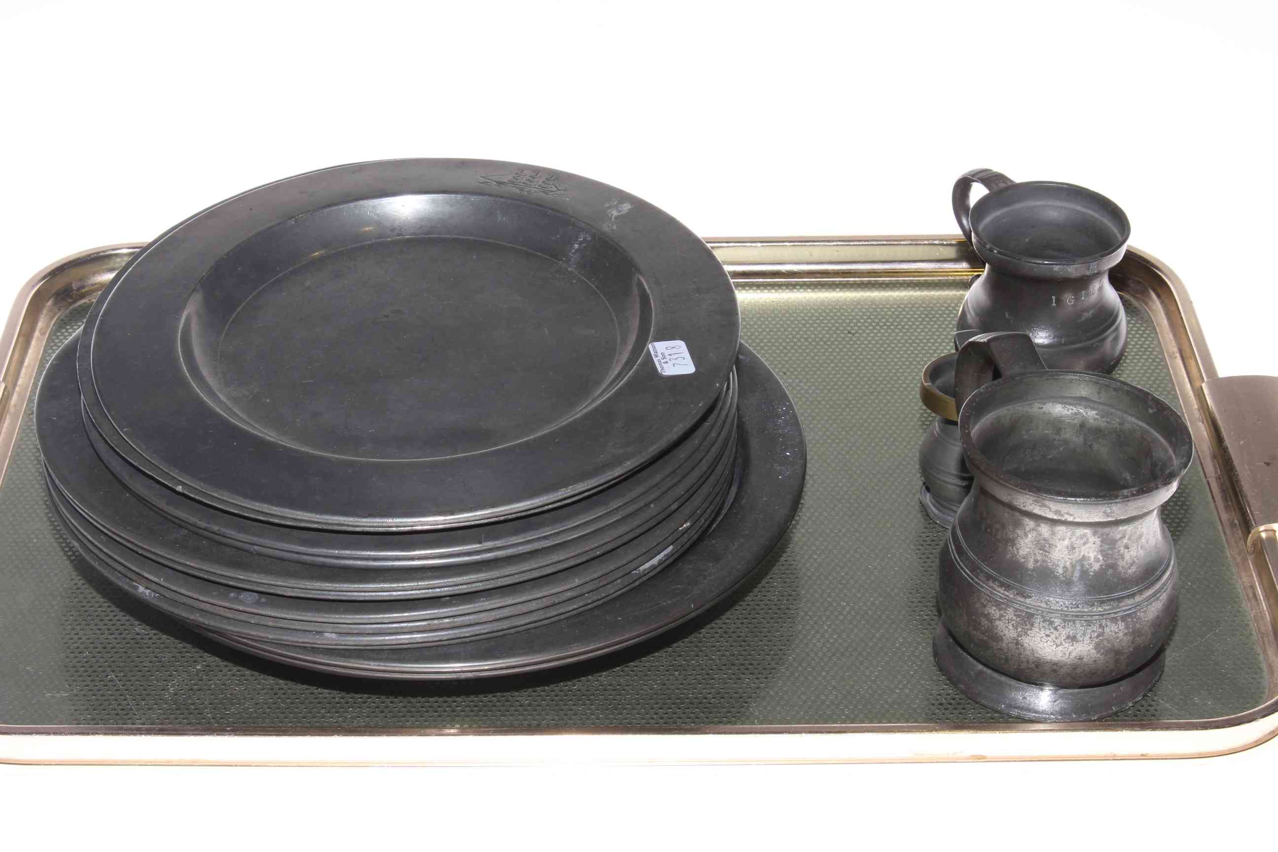 Assorted antique pewter plates and three pewter measures.