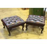 Pair ox blood deep buttoned leather footstools on cabriole legs.