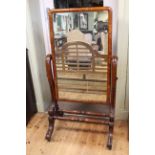 Victorian mahogany cheval mirror on scrolled supports, 152cm by 83cm.