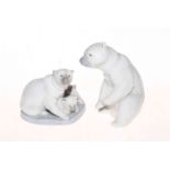 Two Lladro polar bear groups, one with cubs.