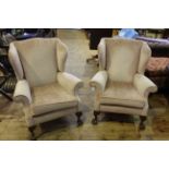 Pair wing back armchairs on ball and claw legs.