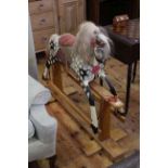 Sponge painted rocking horse on safety stand, 100cm by 122cm.