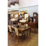 Walnut eight piece dining suite comprising four door serpentine front sideboard,