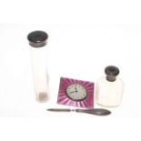 Silver and pink enamel clock, two silver topped toilet bottles and nail file (4).