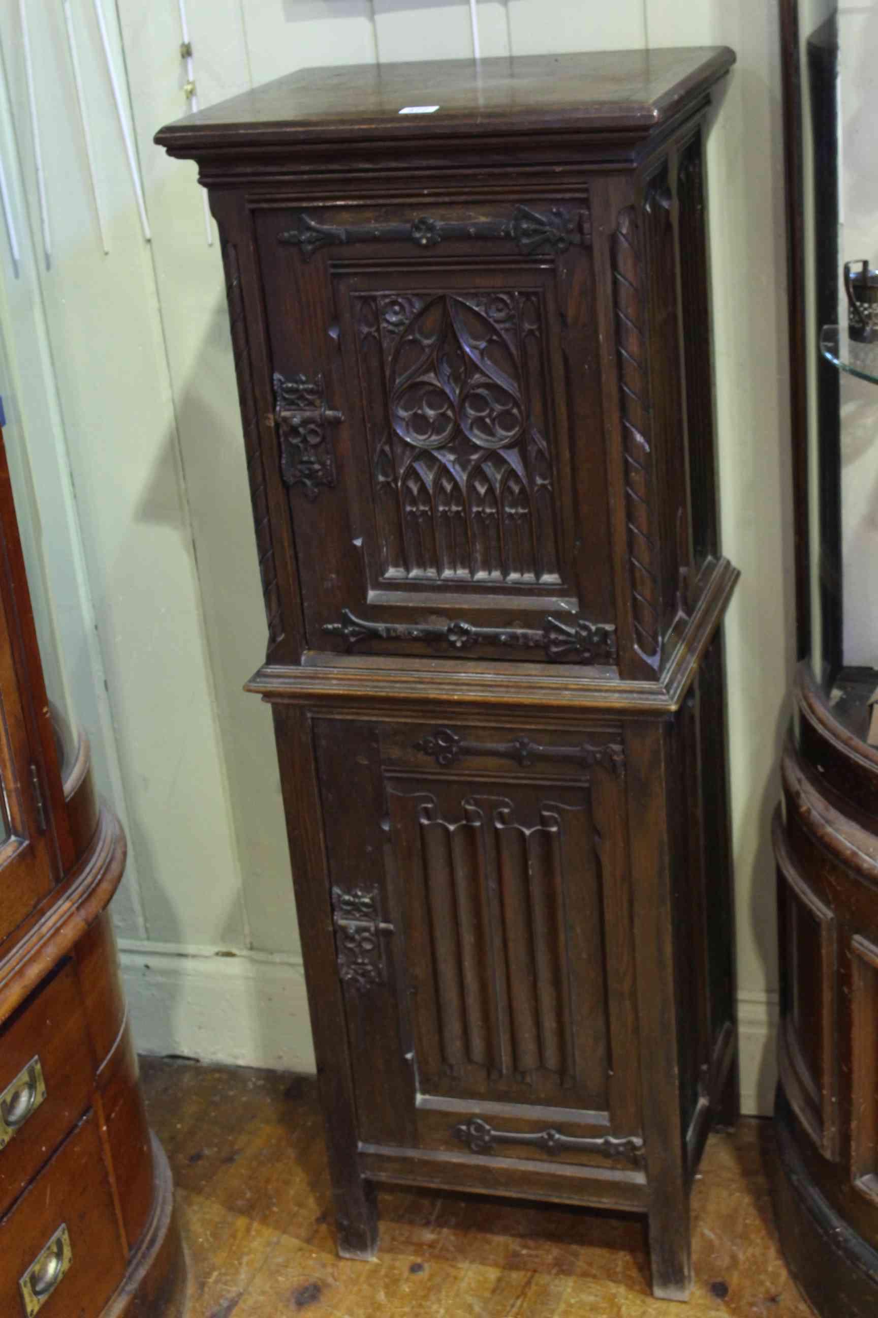 Oak Gothic style two door slim cabinet, 127cm by 46cm.
