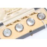 Cased set of 9 carat gold and mother of pearls dress shirt buttons.