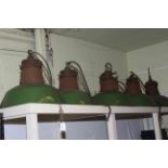 Five green shaded industrial light fittings.