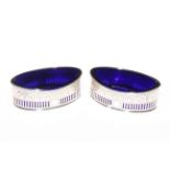 Pair of oval silver cruets with blue glass liners, Sheffield 1906.